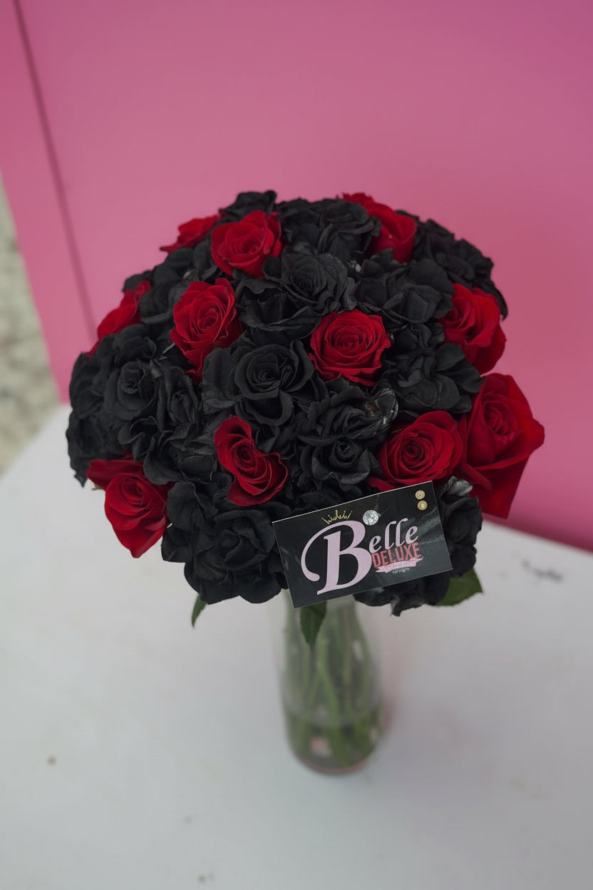Black and red roses on vase